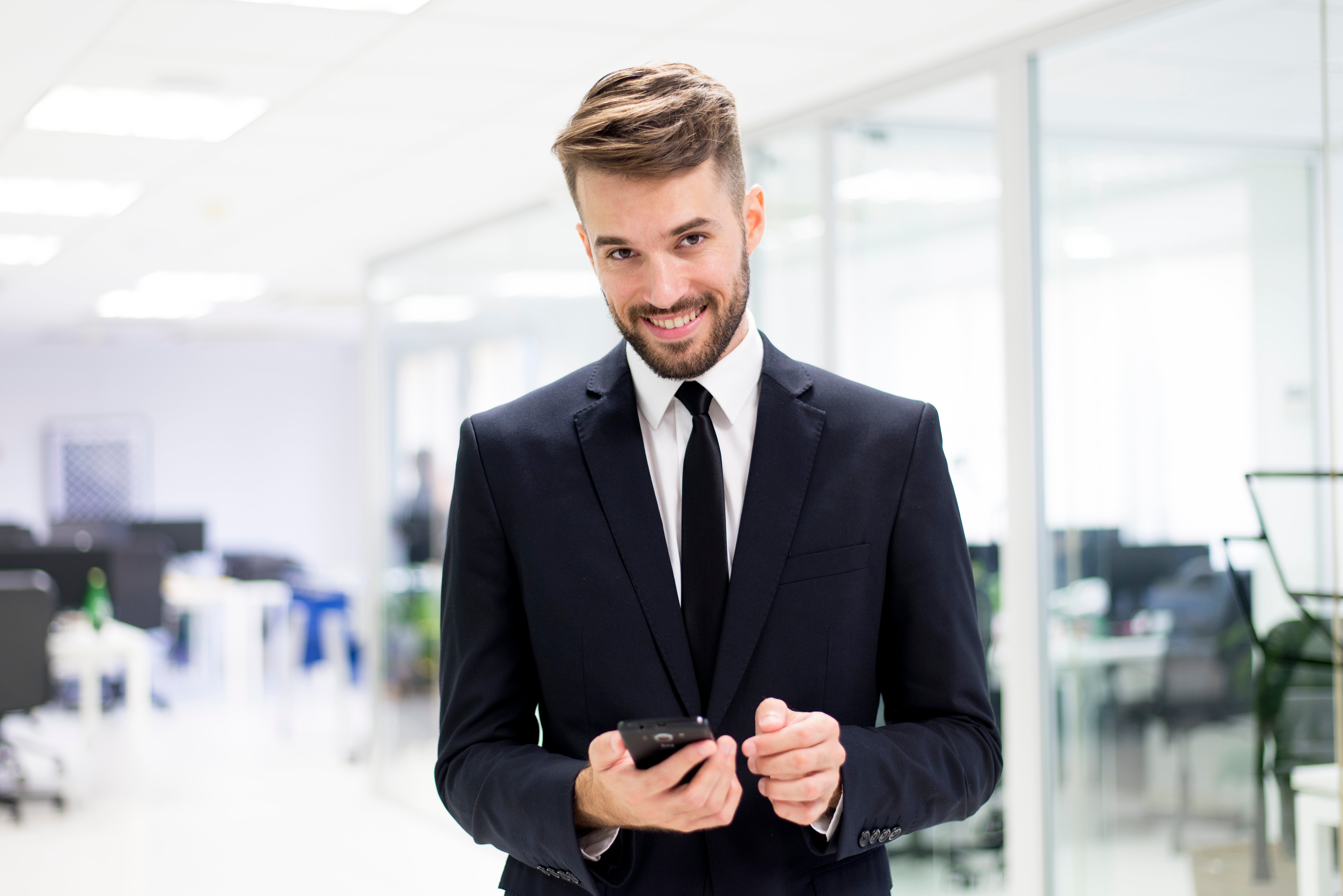 sourire-homme-elegant-avec-un-smartphone